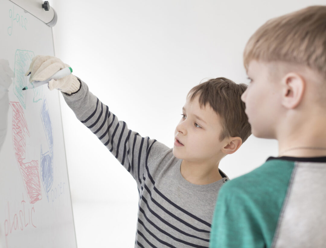 adorable-young-boys-drawing-recycle-sign